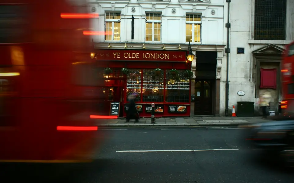A London street with a red double-decker bus, used as an example video frame